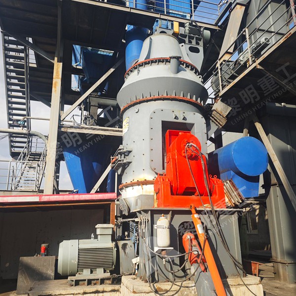 Technician performing laser alignment on a vertical roller mill grinding table